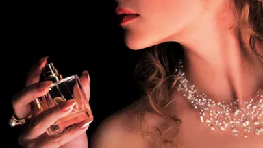 Woman applying perfume OR Woman spraying perfume